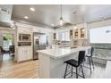 Modern kitchen with white cabinetry, quartz countertops, and stainless steel appliances at 8008 E Del Rubi Dr, Scottsdale, AZ 85258