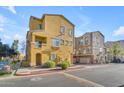 Front view of a yellow townhome with landscaping at 900 S 94Th St # 1066, Chandler, AZ 85224