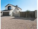 Two-story house with a brown gate and gravel landscaping at 9089 W Troy Dr, Arizona City, AZ 85123