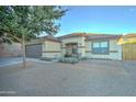 Charming one-story house with a spacious front yard and tree at 9136 E Plata Ave, Mesa, AZ 85212