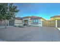 Single-story home with brick driveway and wooden gate at 9136 E Plata Ave, Mesa, AZ 85212