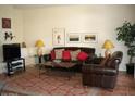 Comfortable living room featuring a leather sofa and warm decor at 9707 E Mountain View Rd # 1430, Scottsdale, AZ 85258