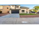 Two-story house with a black garage door and artificial turf at 9920 W Calle Encorvada --, Phoenix, AZ 85037