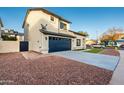 Two-story house with a side view showcasing the garage and landscaping at 9920 W Calle Encorvada --, Phoenix, AZ 85037