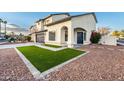 Two-story house with a walkway leading to the front door and artificial turf at 9920 W Calle Encorvada --, Phoenix, AZ 85037