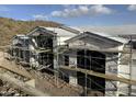 Rear view of under construction home with large windows at 16025 N Ringtail Trl, Fountain Hills, AZ 85268