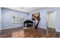 Bright room with hardwood floors, piano, harp, and plenty of natural light at 1809 E Campbell Ave, Phoenix, AZ 85016