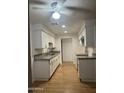 Clean galley kitchen featuring white cabinets and granite countertops at 2802 N 50Th Ln, Phoenix, AZ 85035