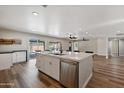 Open concept kitchen with white island, stainless steel appliances, and hardwood floors at 2928 E Cortez St, Phoenix, AZ 85028