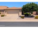 Inviting home featuring a spacious driveway leading to a two-car garage, complemented by desert-friendly landscaping at 3056 E Palm Beach Dr, Chandler, AZ 85249