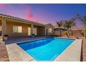 Inviting backyard pool with covered patio and desert landscaping at 3082 E Jade Ct, Chandler, AZ 85286