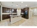 Spacious kitchen with dark wood cabinets, granite countertops, and stainless steel appliances at 333 N Calle Largo --, Mesa, AZ 85207