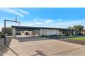 Mid-century modern home with carport and basketball court at 4901 W Soft Wind Dr, Glendale, AZ 85310