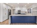 Modern kitchen with white and blue cabinets and stainless steel appliances at 4913 E Acoma Dr, Scottsdale, AZ 85254