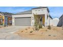 Charming single-story home with desert landscaping, a two-car garage, and a bright yellow front door at 5162 E Umber Rd, San Tan Valley, AZ 85143