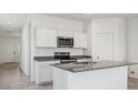 Bright kitchen features white cabinets, granite countertops, stainless steel appliances, and a center island at 5162 E Umber Rd, San Tan Valley, AZ 85143
