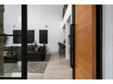 View through a modern glass door into a spacious living area at 6933 E 1St St # B, Scottsdale, AZ 85251