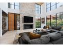 Open living space with a large stone fireplace and high ceilings at 6933 E 1St St # B, Scottsdale, AZ 85251