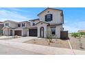 A modern two-story home featuring low maintenance landscaping, a two car garage and stylish shutters at 7416 S 76Th Ln, Laveen, AZ 85339