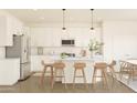 Modern kitchen with white cabinets and island at 7416 S 76Th Ln, Laveen, AZ 85339
