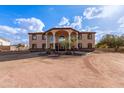 Two-story house with stucco exterior, large windows, and a porte-cochere at 8315 E Palm Ln, Mesa, AZ 85207
