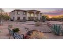 Landscaped front yard with a fire pit and a bench, in front of a two story house at 8315 E Palm Ln, Mesa, AZ 85207