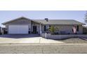 Single story home with gray exterior, landscaped yard, and attached garage at 8547 W Magnum Dr, Arizona City, AZ 85123