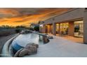 Relaxing kidney-shaped pool with waterfall feature in the backyard at 11453 E Mark Ln, Scottsdale, AZ 85262