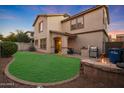 Spacious backyard with fire pit, patio, and grassy area at 1174 E Canyon Creek Dr, Gilbert, AZ 85295