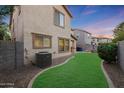 Landscaped backyard featuring a grassy area and privacy wall at 1174 E Canyon Creek Dr, Gilbert, AZ 85295