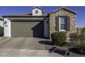 Single story home with stone facade and two car garage at 13658 W Sandridge Dr, Sun City West, AZ 85375