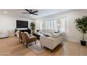 Living room featuring neutral decor and a large window with shutters at 1722 Leisure World --, Mesa, AZ 85206