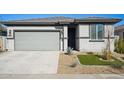 Modern curb appeal with gray exterior, two-car garage, and front landscaping at 17852 W Country Club Ter, Surprise, AZ 85387