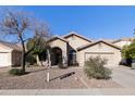 Single-story home with a two-car garage and landscaped front yard at 1918 E Saratoga St, Gilbert, AZ 85296