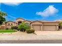 Single-story home with three-car garage, desert landscaping, and neutral exterior at 20546 N 83Rd Pl, Scottsdale, AZ 85255