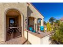 Inviting front porch with wrought-iron gate and comfortable seating at 21268 N 266Th Ln, Buckeye, AZ 85396