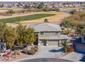 Two-story house with a three-car garage, and a golf course view at 22155 N Cline Ct, Maricopa, AZ 85138