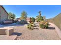 Landscaped backyard oasis with a fountain and spa at 22155 N Cline Ct, Maricopa, AZ 85138