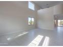 Spacious living room with high ceilings and large windows at 22155 N Cline Ct, Maricopa, AZ 85138