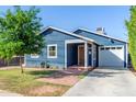 Front view of a renovated blue house with a white garage at 2614 N 15Th St, Phoenix, AZ 85006