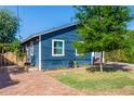 Side view of a charming blue house with a brick walkway and a tree at 2614 N 15Th St, Phoenix, AZ 85006