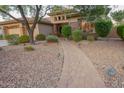 Landscaped front yard with a winding brick path leading to the home entrance at 2740 S Honeysuckle Ln, Gilbert, AZ 85295