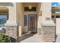 Elegant front entry with decorative door and stone accents at 2910 E Quiet Hollow Ln, Phoenix, AZ 85024