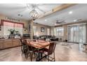 Open concept dining area with a rustic wooden table and seating at 36248 W Cartegna Ln, Maricopa, AZ 85138