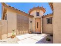 Inviting entryway with a charming courtyard and double doors at 36248 W Cartegna Ln, Maricopa, AZ 85138