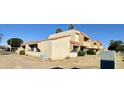 View of building exterior, tan stucco, tile roof and landscaping at 4730 W Rose Ln, Glendale, AZ 85301