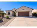 Single-story home with brown garage door and desert landscaping at 5352 N Gila Trail Dr, Eloy, AZ 85131