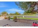 Relaxing patio with park view, brick pavers, and potted plants at 5402 E Paradise Ln, Scottsdale, AZ 85254