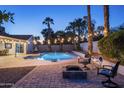 Inviting backyard oasis featuring a sparkling pool and fire pit at 6102 E Nisbet Rd, Scottsdale, AZ 85254