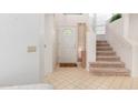 Bright entryway with tiled floors and a staircase leading upstairs at 6439 E Redmont Dr, Mesa, AZ 85215